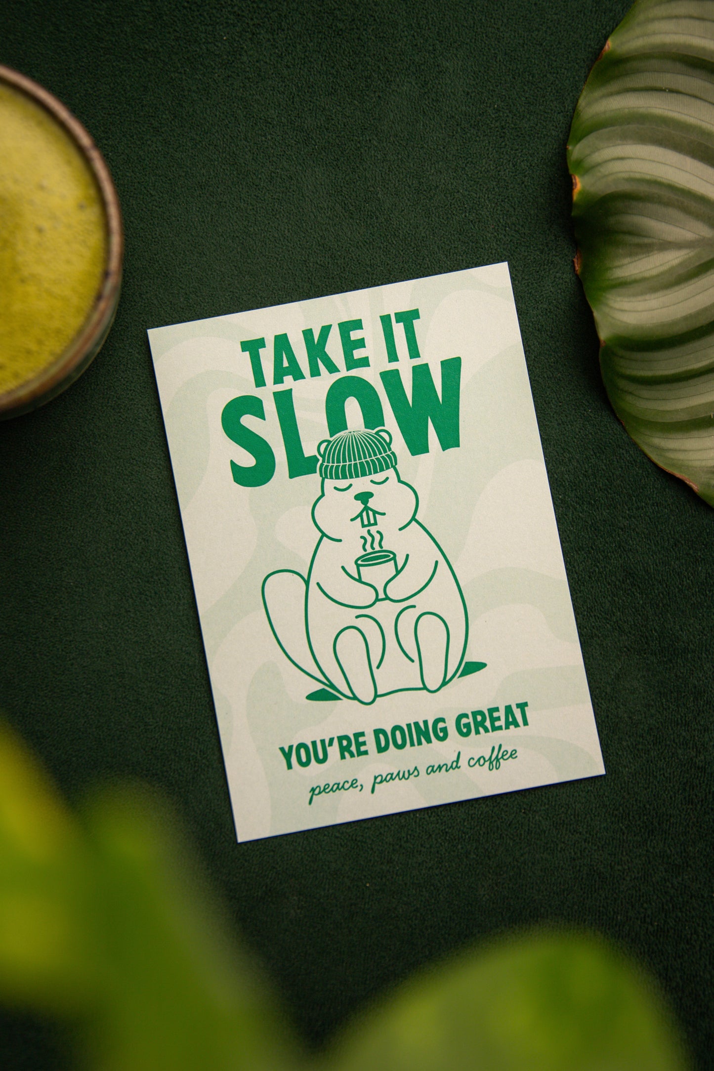 Murmeltierkarte die entspannt und einen Kaffee oder Tee in der Hand hält